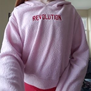Pink hoodie that says "Revolution"